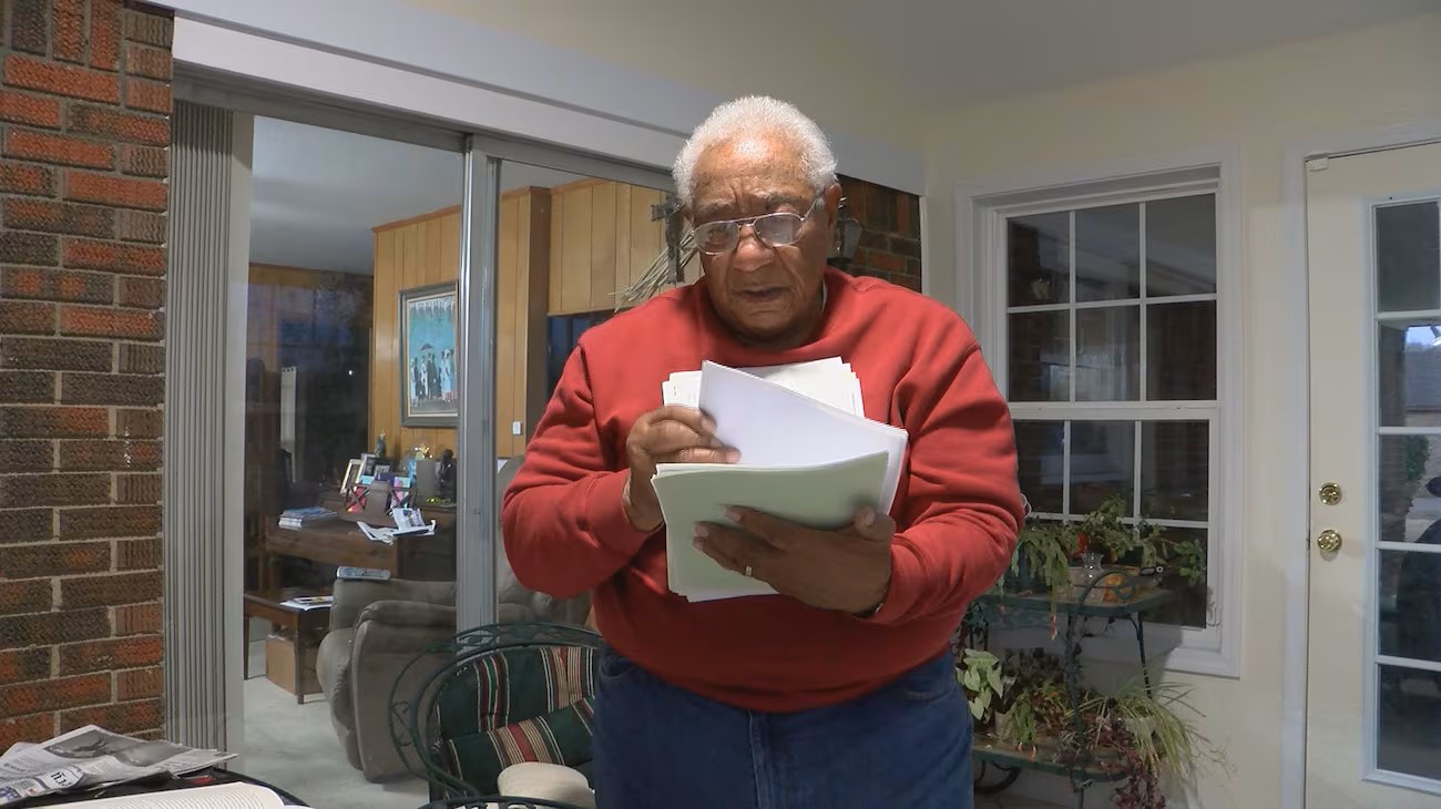 Crear flips through documents filled with information on his lineage